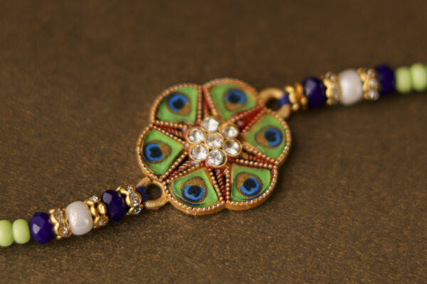 Peacock Feather Designer Rakhi with Stone Centerpiece