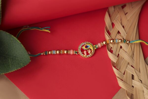 Peacock Feather Rakhi with Ganesha Charm